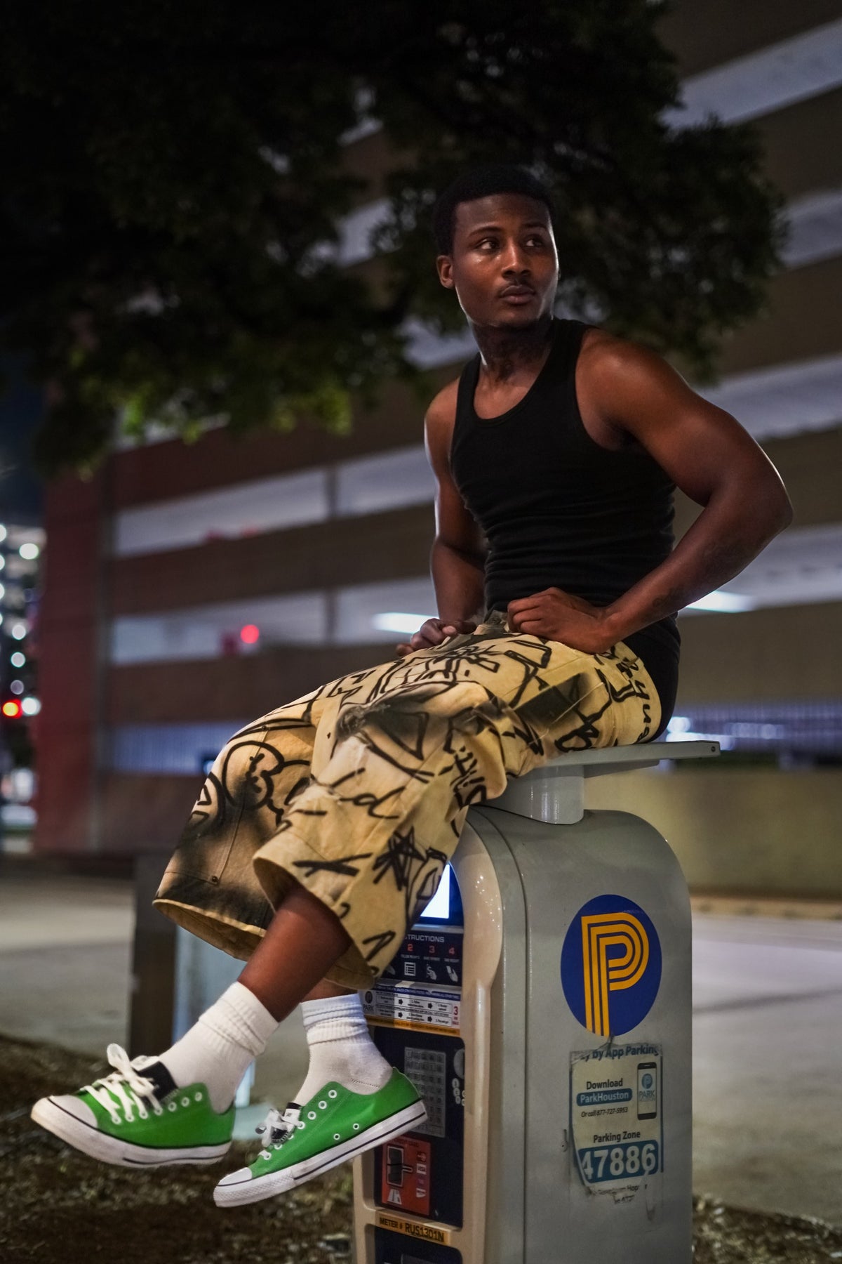 Model seated outdoors at night wearing Graffiti Carpenter Capris