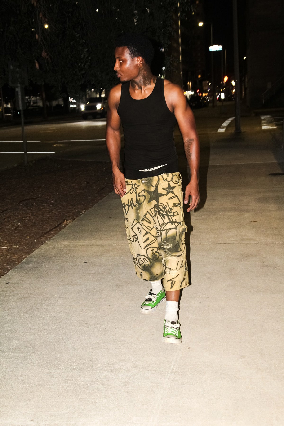 Model walking at night in Graffiti Carpenter Capris